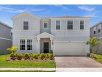 Charming two-story home with a welcoming front entrance and landscaped yard at 4141 Lana Ave, Davenport, FL 33897