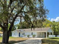 Newly painted one-story home with carport and landscaped yard at 4423 Reaves Rd, Kissimmee, FL 34746