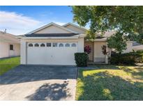 One-story house with attached garage and well-manicured lawn at 4683 Cheyenne Point Trl, Kissimmee, FL 34746