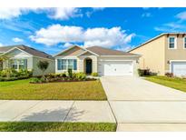 Charming single-story home with a two-car garage and landscaped front yard at 527 Noble Ave, Davenport, FL 33837