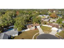 Aerial view of a house with a pool, showcasing its location in a residential neighborhood at 8438 Bay Oak Ct, Orlando, FL 32810