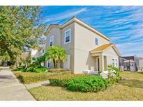 Two-story house with tan siding, tile roof, and landscaping at 4577 Alberto Cir, Kissimmee, FL 34746