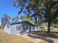 Charming updated home with blue and white exterior and large driveway at 933 Windsor St, Lakeland, FL 33803