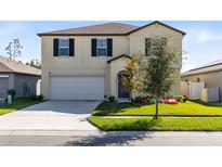 Two-story house with a large yard, two-car garage, and neutral color palette at 2175 Old Mining Rd, Lakeland, FL 33801