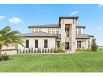 Two-story home with stone accents and a three-car garage at 3167 Whisper Wind Dr, St Cloud, FL 34771
