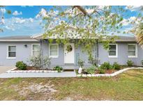 Gray house with white trim, landscaping, and a walkway at 723 Florida Pkwy, Kissimmee, FL 34743