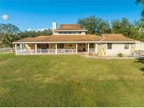 Ranch-style home with a large yard and wrap-around porch at 2801 S Granada Blvd, Kissimmee, FL 34746