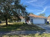 Single-story house with attached garage and well-maintained lawn at 308 Coventry Estates Blvd, Deltona, FL 32725