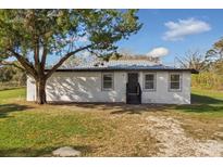 Newly constructed home with metal roof, fresh landscaping, and a spacious yard at 4950 Nova Ave, St Cloud, FL 34773