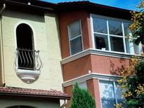 Tan and red two-story building with unique architectural details at 5124 Conroy Rd # 635, Orlando, FL 32811