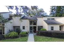 Tan two-story townhouse with a landscaped yard and walkway at 72 Aspen Dr, Haines City, FL 33844