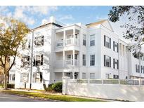 White three-story building with black shutters and white picket fence at 453 Water St, Kissimmee, FL 34747