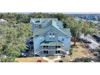 Aerial view of a light blue multi-unit building with green roof at 5980 Westgate Dr # Apt 103, Orlando, FL 32835