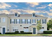 Two-story townhome with gray shutters and a neutral color scheme at 720 Siena Palm Dr # 202, Celebration, FL 34747