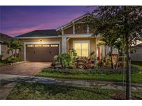 Inviting one-story home with a landscaped front yard and a two-car garage at 5043 Vantage Ct, St Cloud, FL 34772