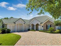 Beautiful stone and shingle home with 3-car garage at 1501 Sunset Pointe Pl, Kissimmee, FL 34744