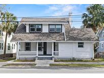 Charming two-story house with white siding and a porch at 405 S Ridgewood Ave, Daytona Beach, FL 32114