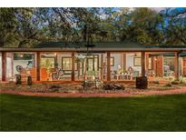 Expansive covered patio with fire pit, perfect for outdoor entertaining at 10820 Sw 31St Way, Webster, FL 33597