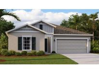 New home exterior features a two-car garage and attractive landscaping at 1153 Deepwater Cir, Eagle Lake, FL 33839