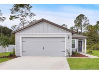 Two-car garage with gray siding at 616 Marion Oaks Blvd, Ocala, FL 34473