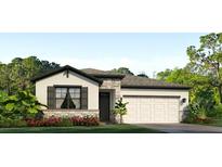 One-story home with white and stone exterior, a two-car garage, and landscaping at 4979 Nw 39Th Loop, Ocala, FL 34482