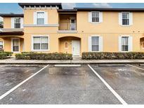 Townhouse exterior with parking spaces at 2705 Bushman Dr, Kissimmee, FL 34746