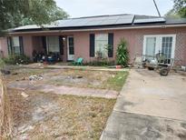 Ranch-style home with solar panels and needs landscaping at 136 Madera Dr, Winter Haven, FL 33880