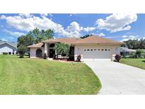 Single-story house with two-car garage and landscaping at 2163 Rainbower Ct, Lakeland, FL 33810