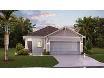 One-story home with light blue exterior, two-car garage, and landscaping at 2123 Green Valley St, Daytona Beach, FL 32124