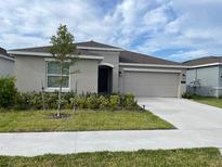 Single-story home with attached garage and landscaped front yard at 6945 Church Lake St, Groveland, FL 34736