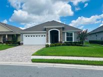 One-story home with a two-car garage and landscaped lawn at 7771 Lake James Blvd, Lakeland, FL 33810