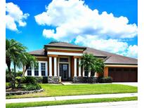 Two story house with columns and a three car garage at 5446 Pebble Beach Dr, Lakeland, FL 33812