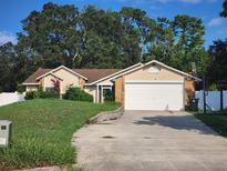 Single-story house with attached garage and basketball hoop at 1505 Prairie Lake Blvd, Ocoee, FL 34761