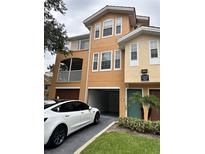 Two-story condo building with attached garage and landscaped grounds at 12031 Villanova Dr # 110, Orlando, FL 32837