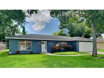 Newly painted blue house with a well-maintained lawn and a two-car garage at 1737 Jacobs Rd, South Daytona, FL 32119