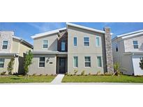 Modern two-story house with stone accents; new construction at 2857 Bookmark Dr, Kissimmee, FL 34746