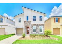 Two-story home with modern design and stone accents at 1959 Tropical Palms Cir, Kissimmee, FL 34747