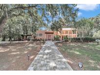 Spanish style home with brick walkway and lush landscaping at 8901 Nw 136Th Avenue Rd, Ocala, FL 34482