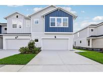 Two-story townhome with gray and blue exterior at 559 Astera Winds Ln, Lake Mary, FL 32746