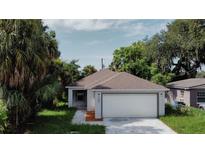 Newly built home with a two-car garage and landscaped yard at 604 W 12Th St, Lakeland, FL 33805