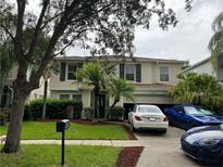 Two-story house with a spacious front yard and attached garage at 12609 Oulton Cir, Orlando, FL 32832