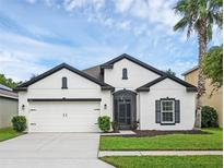 Charming single-story home with white exterior and black accents at 1126 Whitewater Bay Dr, Groveland, FL 34736