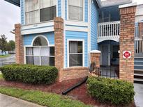 Two-story building with blue siding and brick accents at 2729 N Poinciana Blvd # 117, Kissimmee, FL 34746