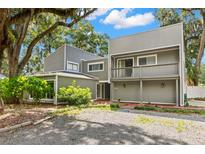 Modern two-story house with a balcony and gravel driveway at 6318 Cedar Ln, Lakeland, FL 33813