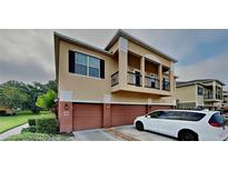 Tan two-story house with two car garage and balcony at 2217 Betsy Ross Ln # A, St Cloud, FL 34769