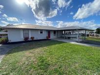 Ranch style home with attached carport and spacious yard at 535 Minnow Ct, Kenansville, FL 34739