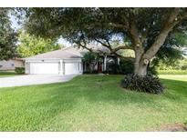 Single-Gathering home exterior with two-car garage at 582 Caledonia Pl, Sanford, FL 32771