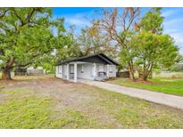 Charming bungalow home with gray exterior and landscaped front yard at 2541 Idlewild St, Lakeland, FL 33801