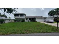Two-story house with a spacious lawn and attached garage at 555 Alachua Dr, Winter Haven, FL 33884