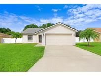 House exterior showcasing a two-car garage at 2740 Oak Hammock Loop, Mulberry, FL 33860